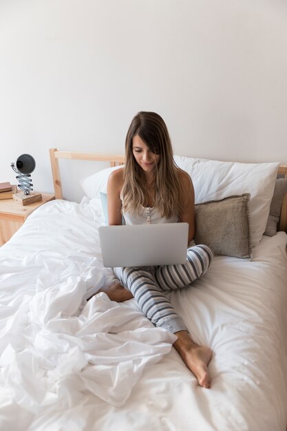 Streaming concept with woman on bed