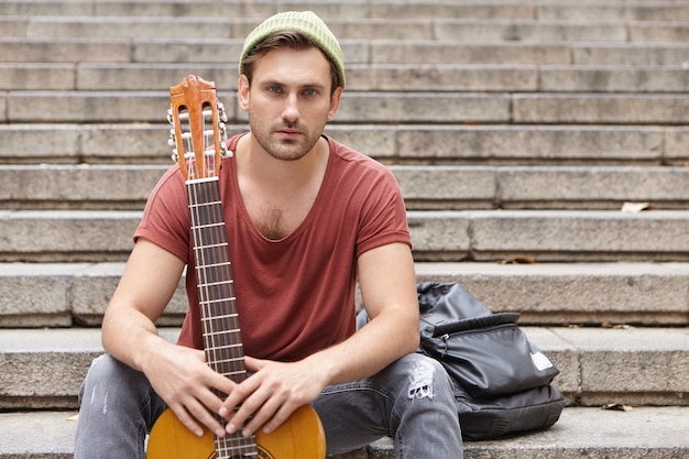 Free photo street musician and his guitar