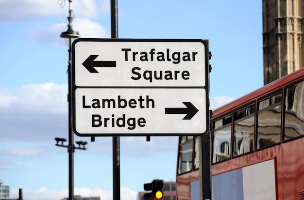 Street sign and double decker bus in london