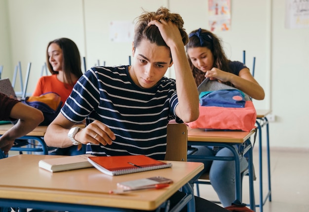 Free photo stressed boy in class