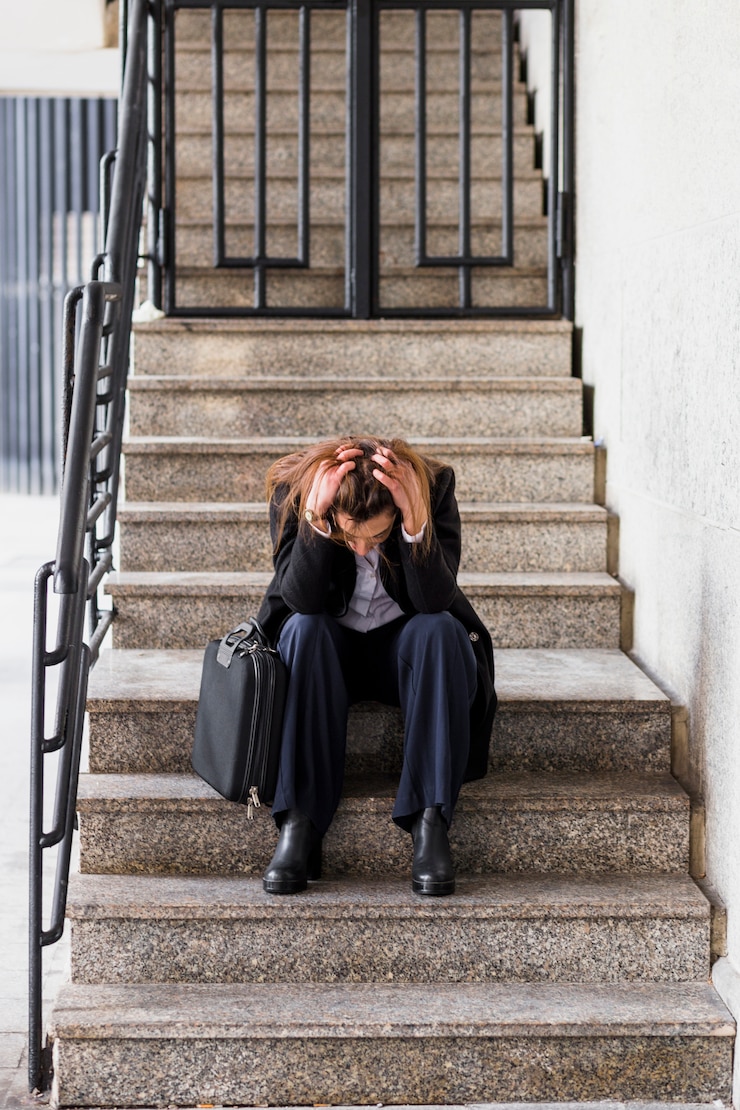 Free Photo stressed business woman sitting on stairs 