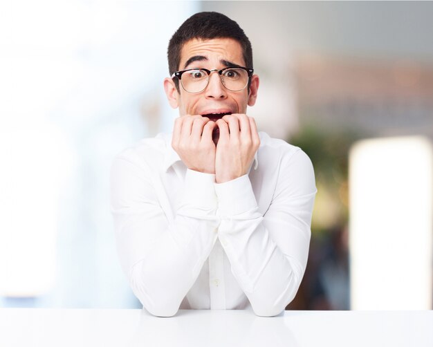 Stressed man biting his nails