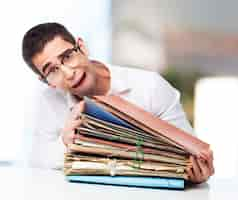 Free photo stressed man looking at a pile of papers