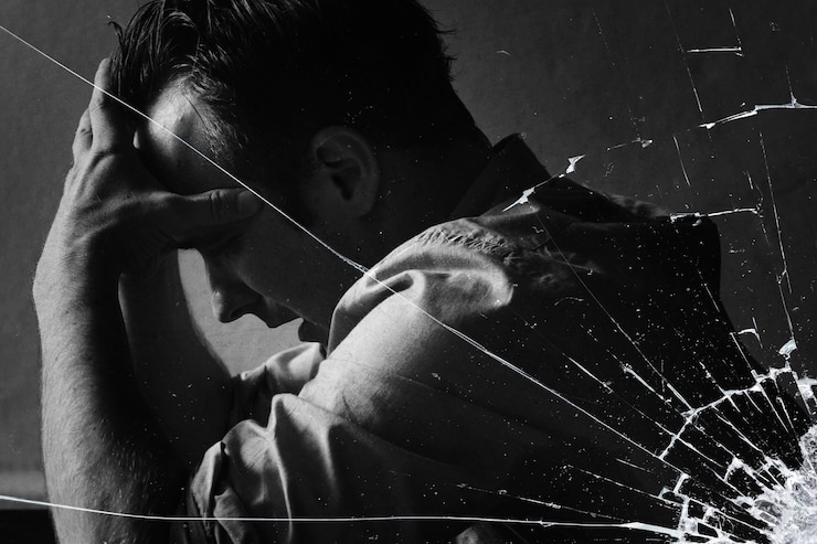 Free Photo stressed man sitting hopelessly with cracked glass effect