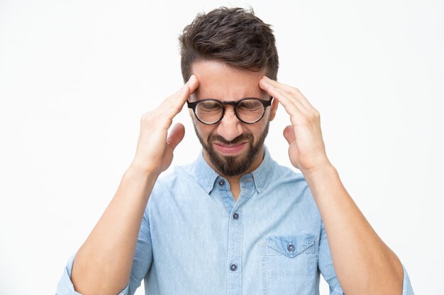 Stressed man suffering from headache