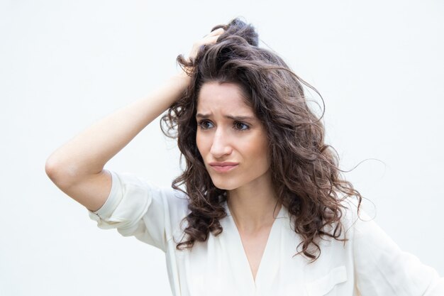 Stressed pensive desperate woman scratching head