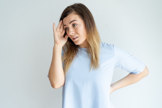 Stressed pretty woman touching head and looking away. Tired middle-aged lady. 