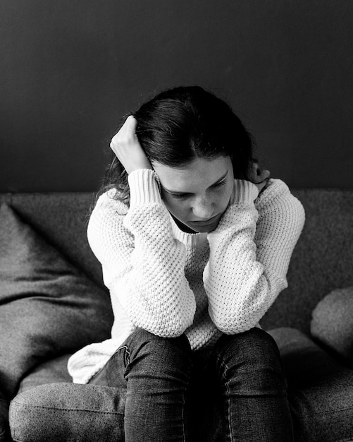 Free photo stressed teenager sitting on a sofa