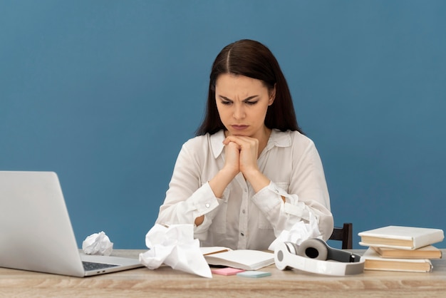 Free photo stressed woman working on laptop