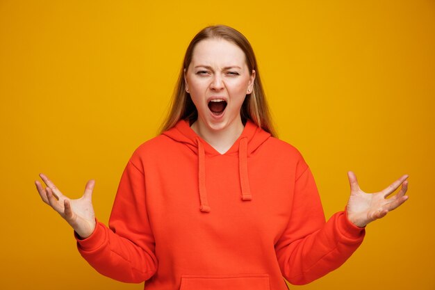 Stressed young blonde woman showing empty hands screaming 