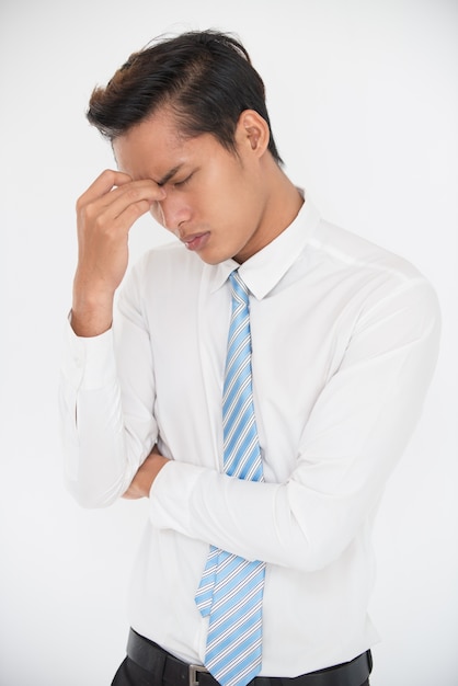 Stressed young businessman trying to solve problem