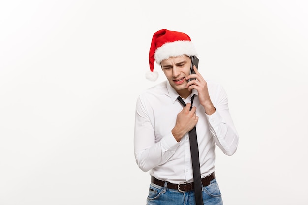 Stressful handsome businessman serious talking on phone on Christmas day.