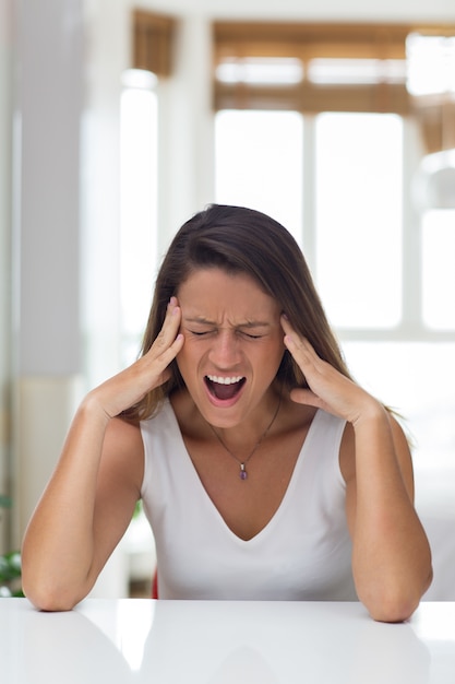 Stressful young woman crying from pain