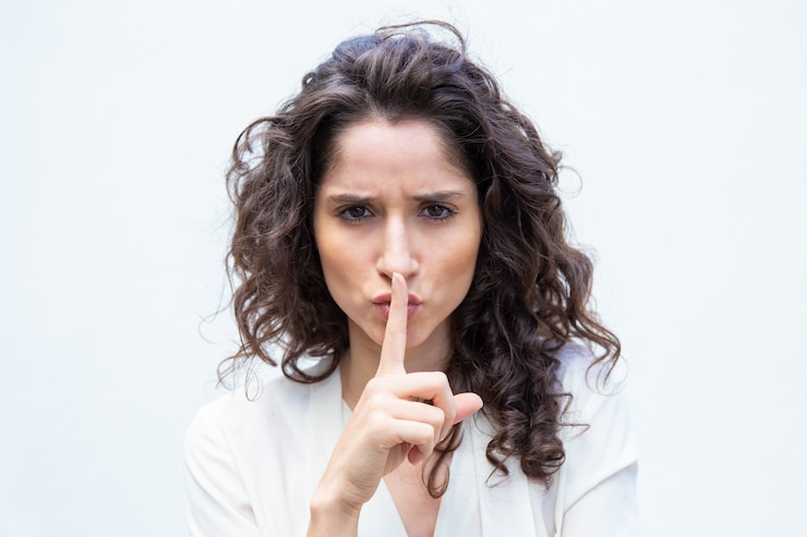 Free Photo strict beautiful woman making shh gesture