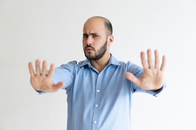 Strict businessman showing handstop sign