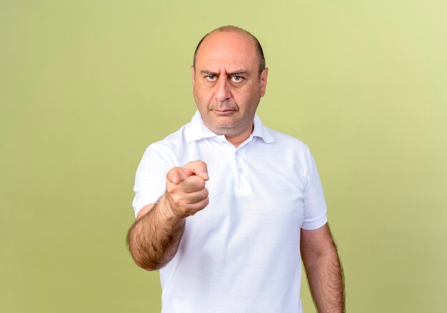 Strict mature man showing you gesture isolated on olive green wall