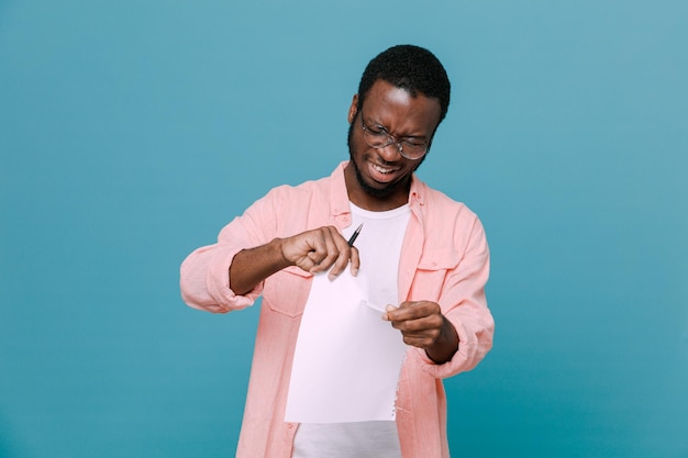 strict tears paper young africanamerican guy isolated on blue background