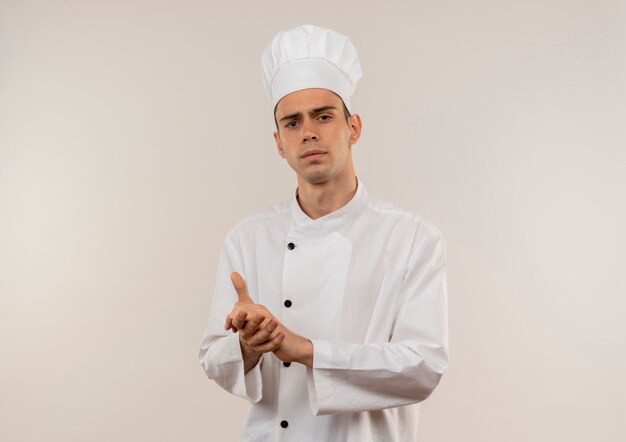 Strict young male cook wearing chef uniform showing handshake gesture