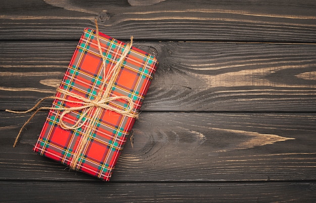 String tied christmas present in wooden background