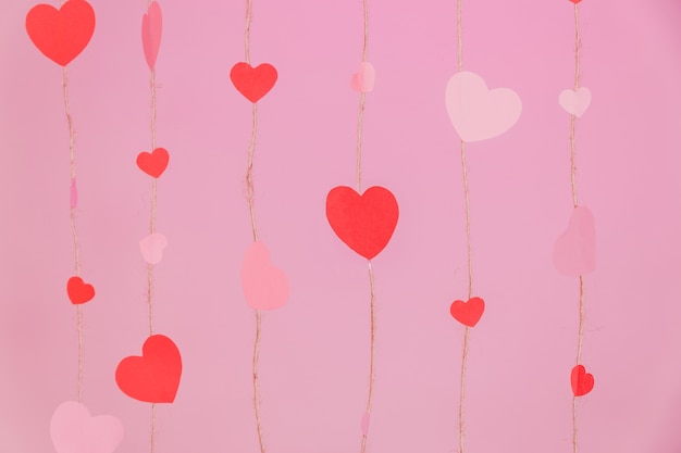 Strings composed of hearts on a pink background