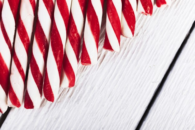 Striped red and white tubes on wood board 