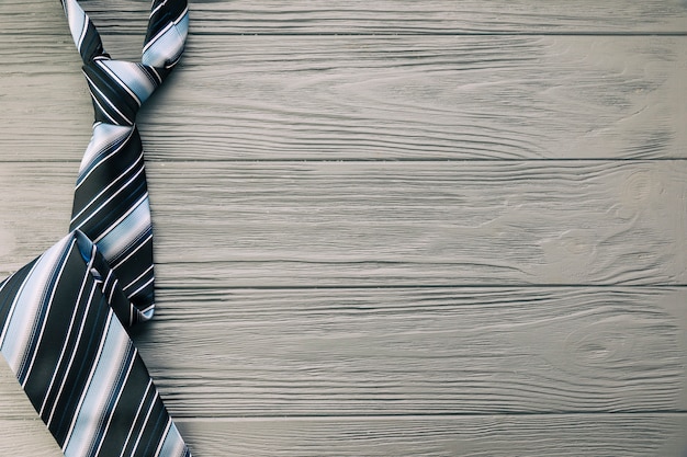 Free photo striped tie on grey desk