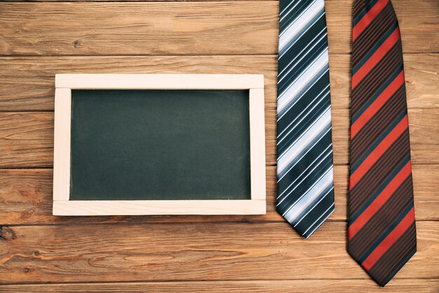 Striped ties on board near blackboard