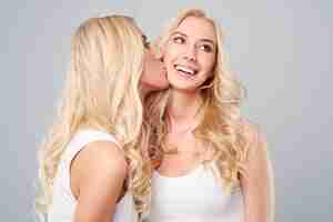 Free photo strong bond between blonde twins