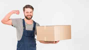 Free photo strong delivery man standing with big box