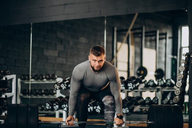 Strong man exercising at the gym