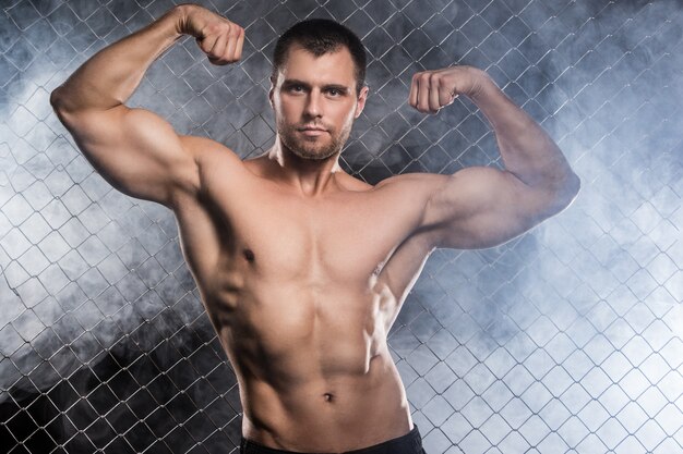 Strong man on fence