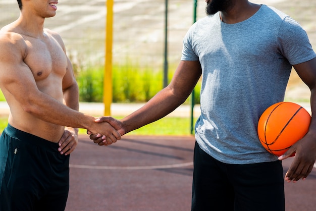 Free photo strong men shake hands  medium shot