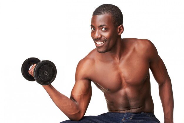 Strong and muscular guy with dumbbell isolated on white 