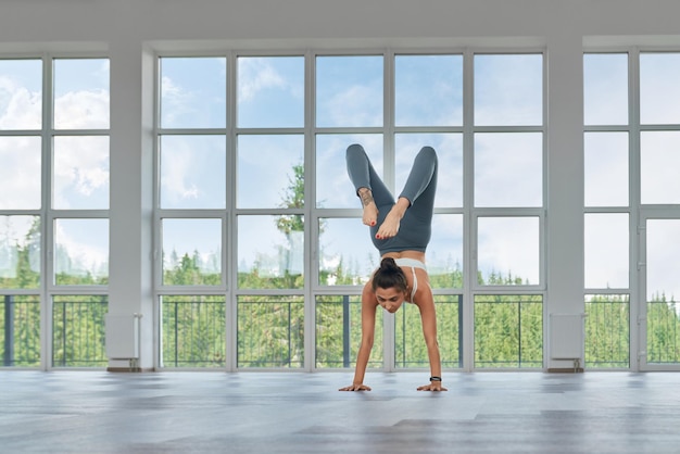 Strong woman in sport clothes training alone indoors