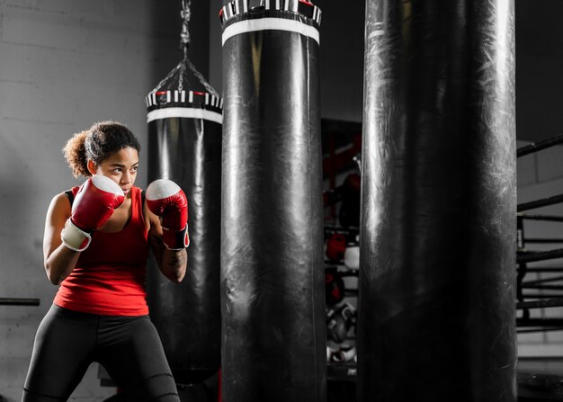 Strong woman training in boxing center