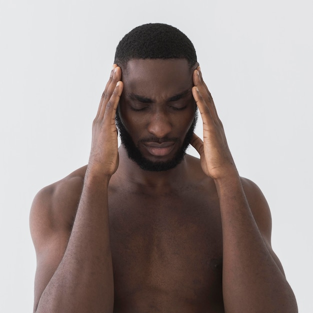 Free photo struggling man holding his head