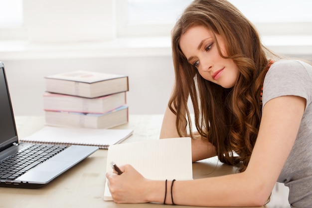 Student. Attractive girl by the table