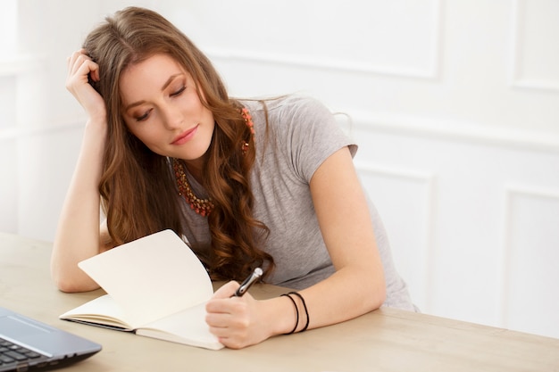 Student. Attractive girl by the table