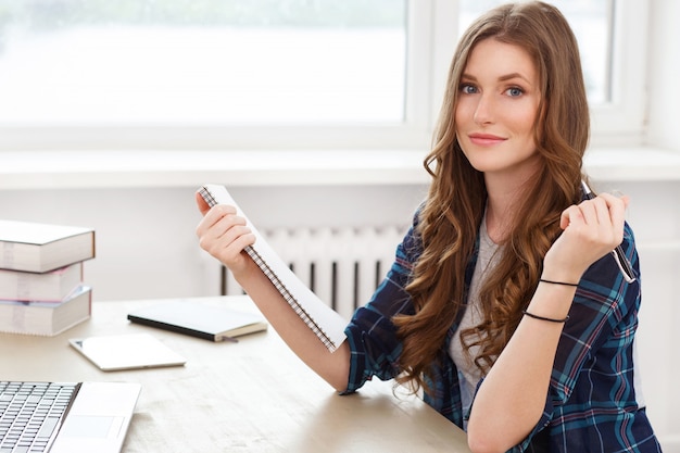 Student. Attractive girl by the table