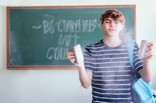 Student, blackboard, chalk and dust