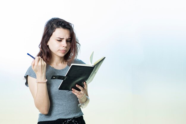 A student or employee reading notes from agenda