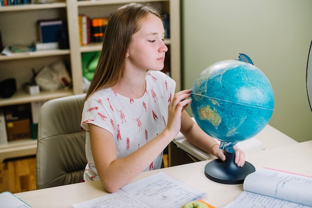 Student exploring globe
