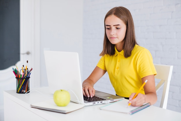 Student girl doing homework at home