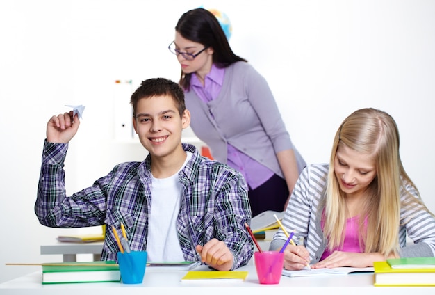 Student holding a paper airplane