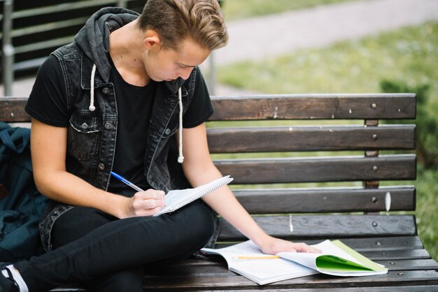 Student learning lecture on bench