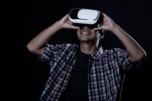 Student man wearing virtual reality goggles, VR headset.