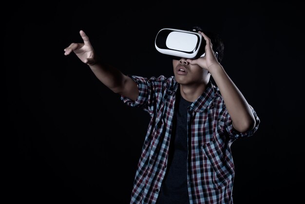 Student man wearing virtual reality goggles, VR headset. 