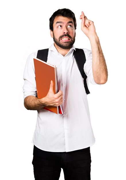 Student man with his fingers crossing