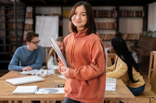 Free photo student posing during a group study session with colleagues