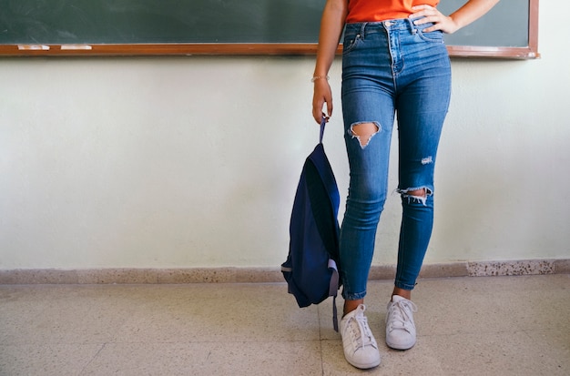 Student's legs and backpack